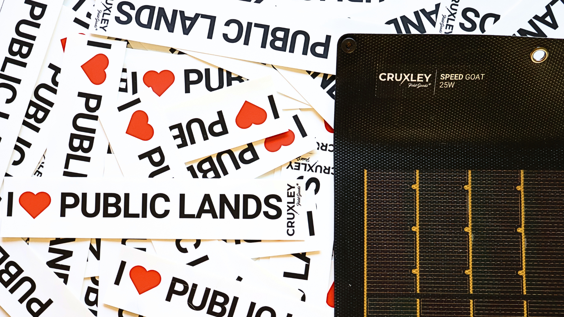 Cruxley solar panel with 'I ❤️ Public Lands' text and logos in the background